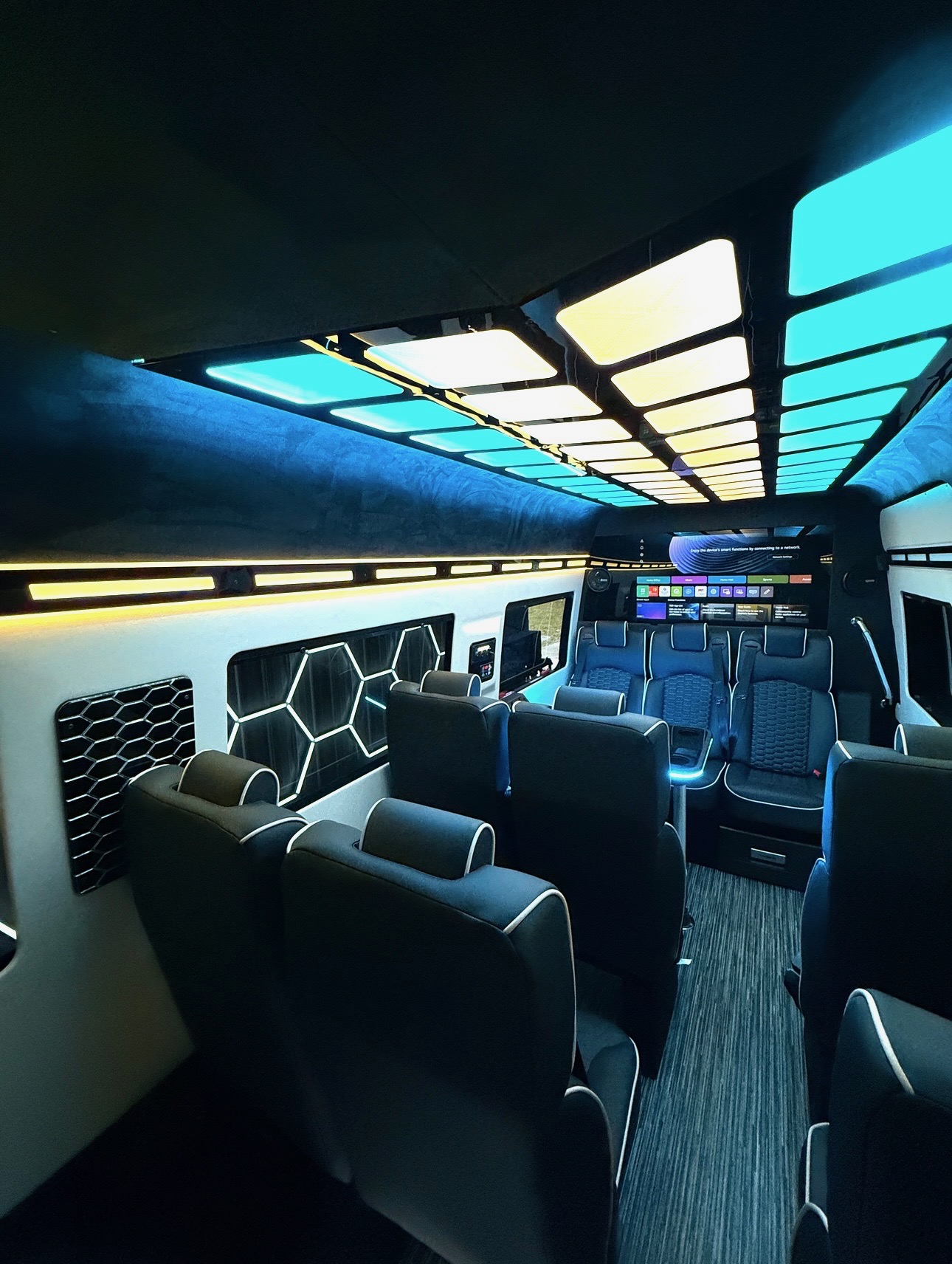 Luxury Sprinter interior with neon accent panels and lounge seating